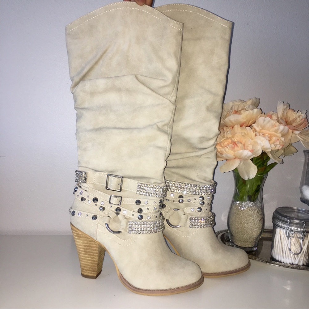 Cream high heeled boots.